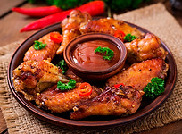 Куриные крылья во фритюре (маринованные в соусе сальса) с аппетитной корочкой, перцем чили и ароматной аджикой